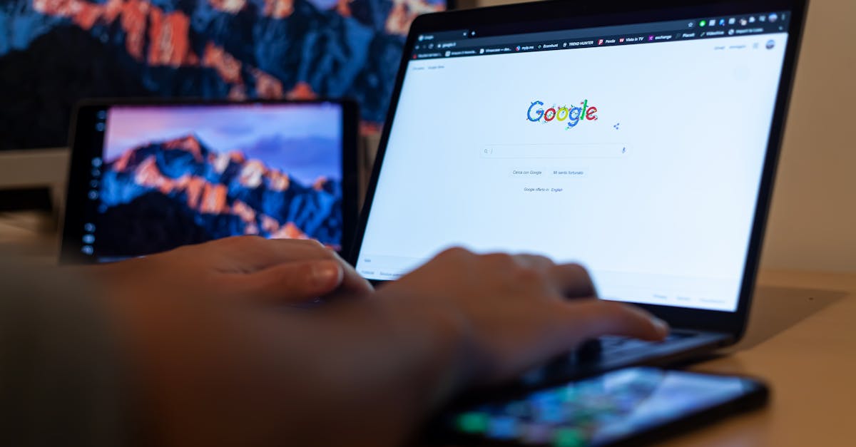 Hands typing on a laptop with Google on screen, in a remote work setup in Milan, Italy.